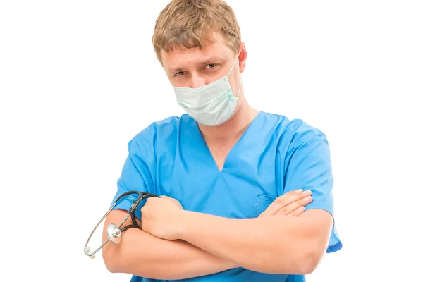 Doctor looking at the camera wearing a mask closely on a white b — Stock Photo, Image