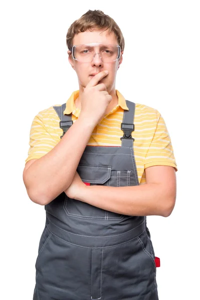 Portrait of a pensive master in overalls on a white background — Stock Photo, Image