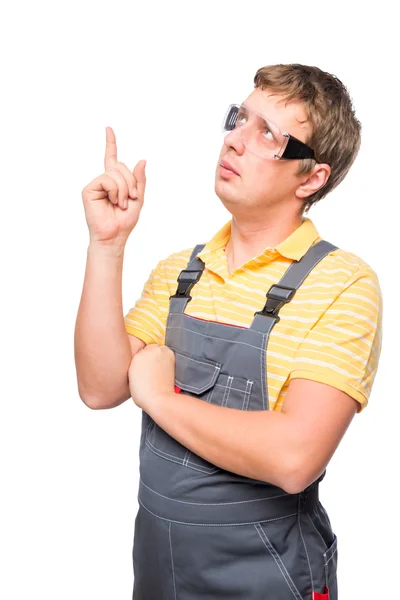 Young master in overalls came up with something shot on a white — Stock Photo, Image