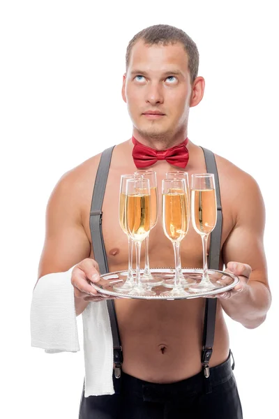 En ung servitör med en naken överkropp med champagne på en fest — Stockfoto