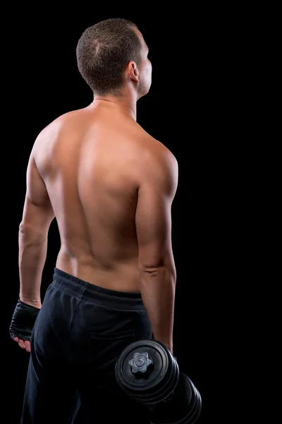 Portret van een bodybuilder met halters uitzicht vanaf de achterkant op een — Stockfoto