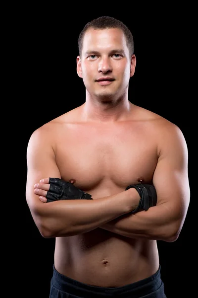 Portrait of a healthy strong man with a naked torso on a black b Stock Photo