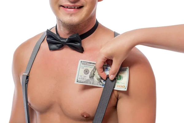 Weibliche Hand legt Dollars unter die Hosenträger Stripper — Stockfoto