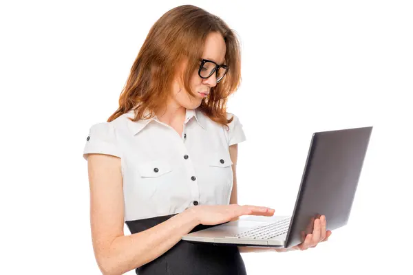 Immersed in the work on the laptop businesswoman at a white back — Stock Photo, Image
