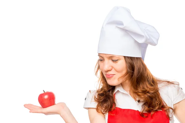 Cozinheiro feminino com maçã vermelha em um fundo branco — Fotografia de Stock
