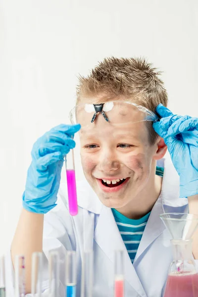 Funny boy dressed as chemist with dirty face after a failed experiment