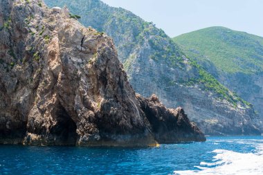 Yunan adasının kayalık kıyıları ve deniz manzarası, tekne manzarası 