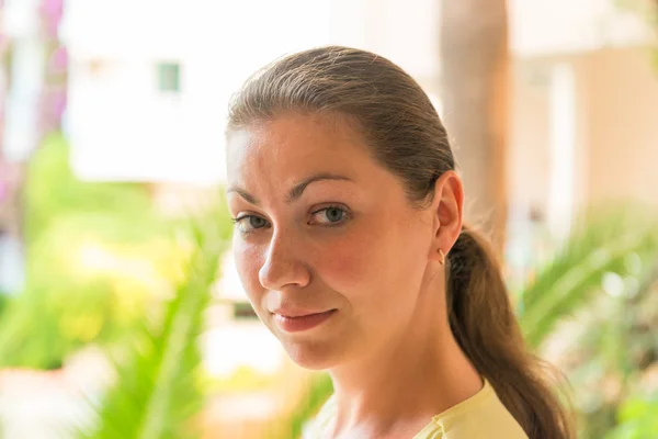 Portrait of a girl on a background of palm leaf — Stock Photo, Image