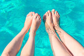 két pár női lábak a medencében