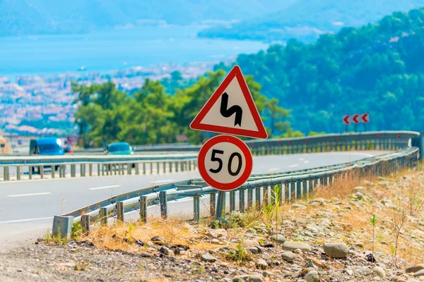 Sign on the road with dangerous turns — Stock Photo, Image