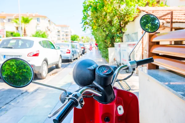 Motocicleta vermelha fica na calçada na rua — Fotografia de Stock