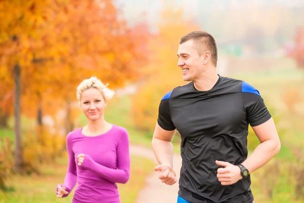 Healthy lifestyle - jogging. a man and a woman running in the mo Royalty Free Stock Photos