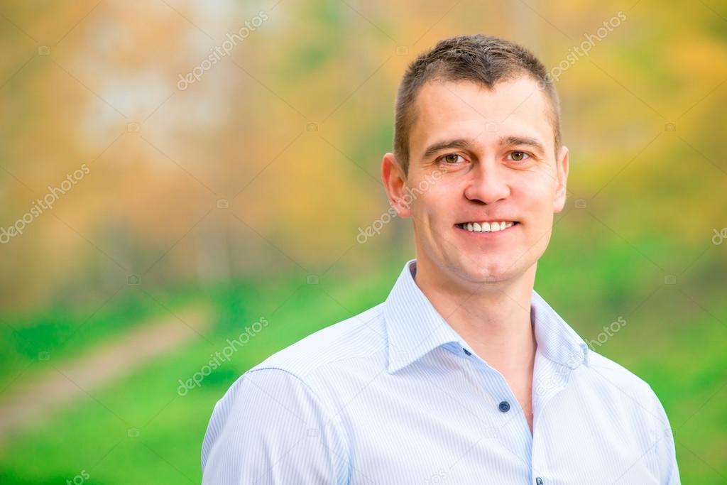 Horizontal portrait of a handsome young man on nature background