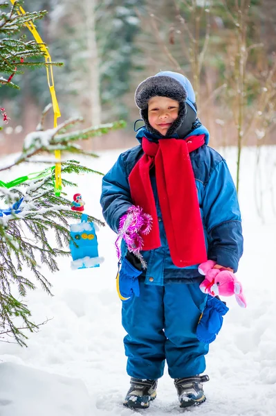 Kleine jongen en kerstboom buitenshuis — Stockfoto