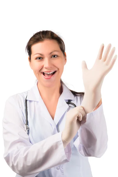 Cheerful woman doctor puts on a rubber glove — Stock Photo, Image