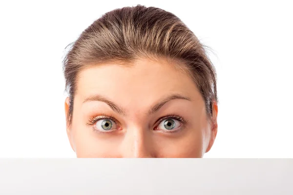Part of a woman's face and white poster on a white background — Stock Photo, Image