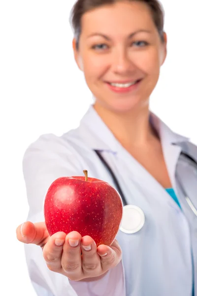 Smiling doctor holding a red apple in the palm — Stock Photo, Image