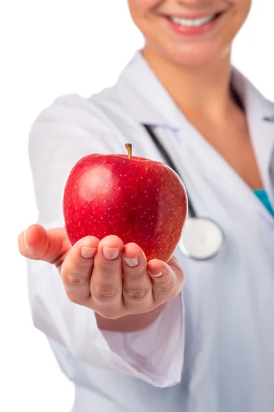 Red ripe apple in the palm of a smiling doctor — Stock Photo, Image