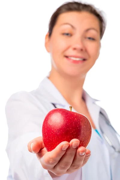 Nurse stretches ripe apple for health, isolated — Stock Photo, Image