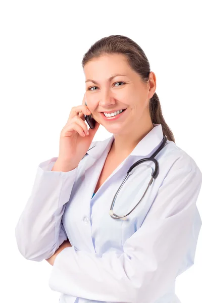 Beautiful brunette Doctor with a phone on a white background — Stock Photo, Image