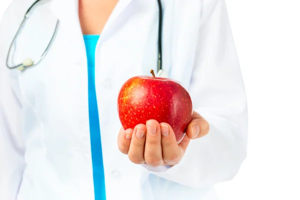 Dentist holding a ripe apple good for the gums — Stock Photo, Image