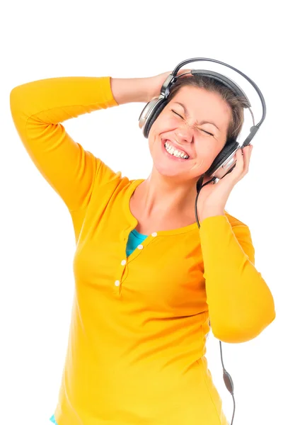 Menina fã de música em fones de ouvido em um fundo branco — Fotografia de Stock