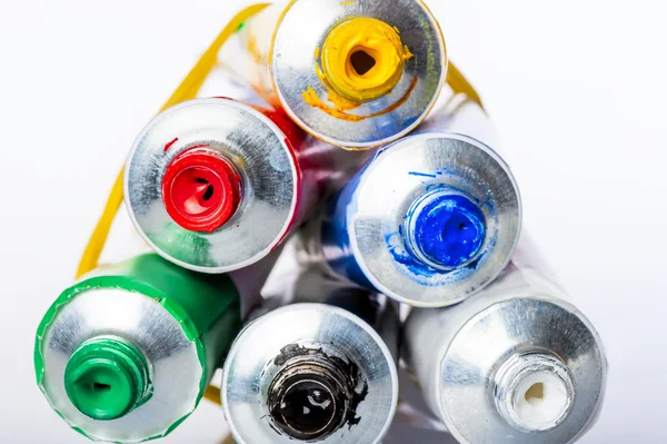 Tubes with colored acrylic paints on a white background — Stock Photo, Image