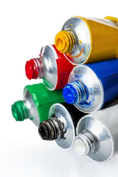 Six tubes with colorful paints on a white background — Stock Photo, Image