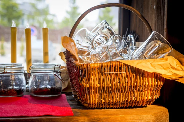 Basket with empty glasses on the kitchen table — Stock Photo, Image