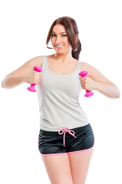 Trainer exercising with dumbbells in studio — Stock Photo, Image