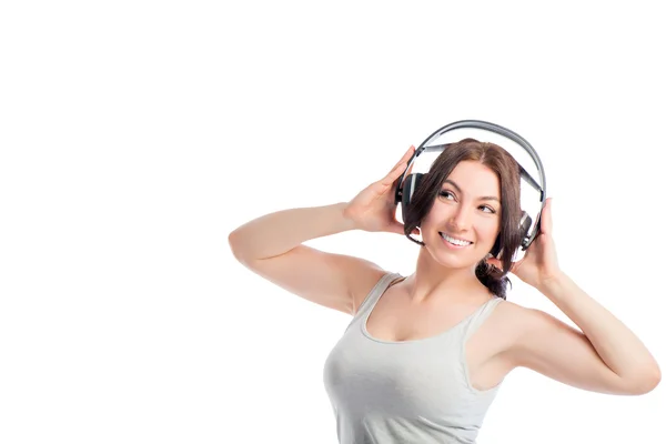 Menina europeia com fones de ouvido em um fundo branco — Fotografia de Stock