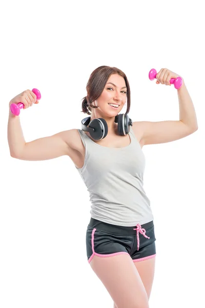 Trainer with a dumbbell and headphones on a white background — Stock Photo, Image