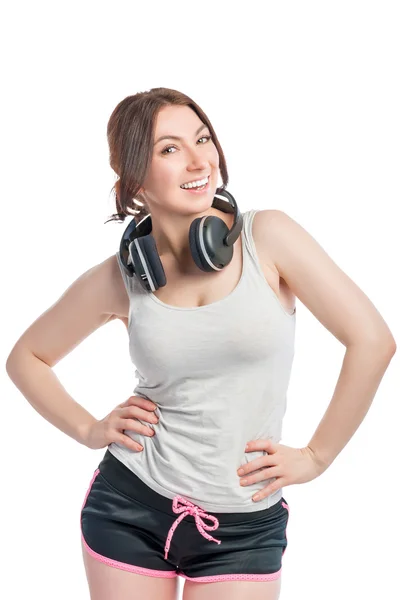 Beyaz arka plan üzerinde kulaklık ile mutlu bir kadın sporcu — Stok fotoğraf