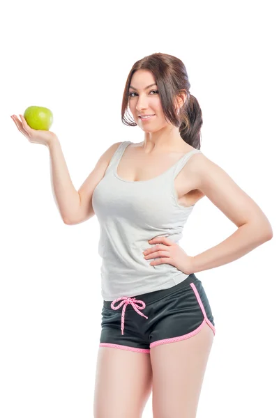 Attractive girl in the sports form with green apple — Stock Photo, Image