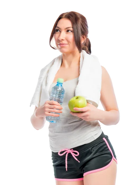 Όμορφη στοχαστικό κοπέλα που κρατά ένα μήλο και ένα μπουκάλι νερό — Φωτογραφία Αρχείου
