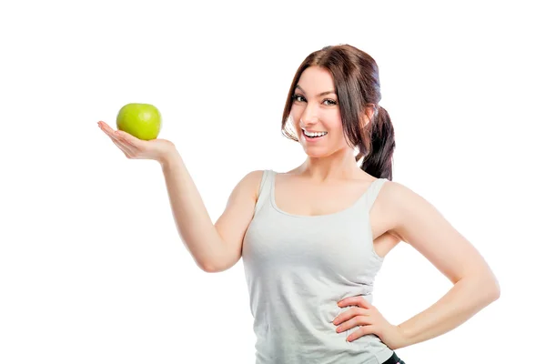Brunette tenant une pomme verte dans la paume de votre main Images De Stock Libres De Droits