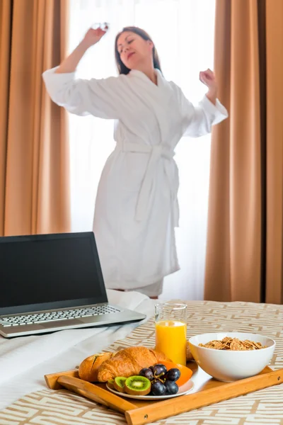 Young woman stretching near the window in the early morning — Stock Photo, Image