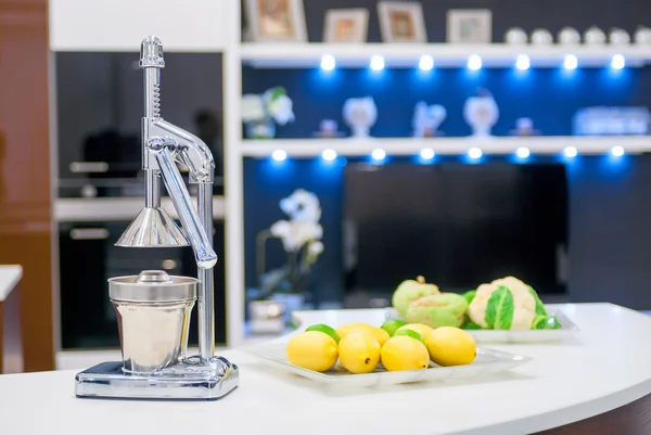 Steel citrus juicer on the kitchen table — Stock Photo, Image