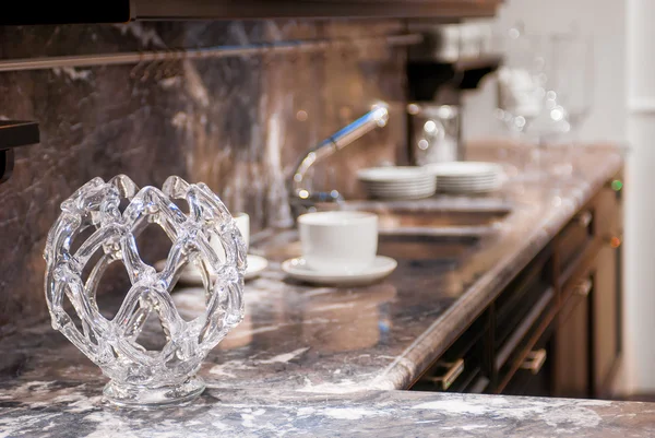 Beautiful glass vase on the marble worktop in the kitchen — Stock Photo, Image