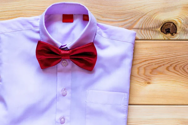 pink shirt and a beautiful bow tie