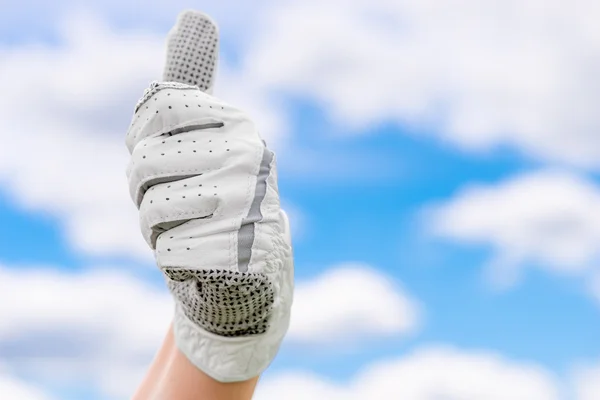 Satisfied gesture of hand in a glove golf against the sky — Stock Photo, Image