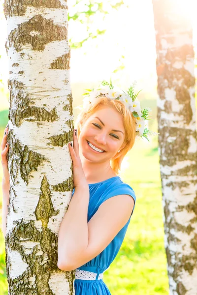 Morena feliz abraçando tronco de bétula no parque — Fotografia de Stock