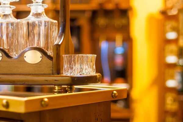 Glasses and decanters for wine on a wooden stand in retro style — Stock Photo, Image