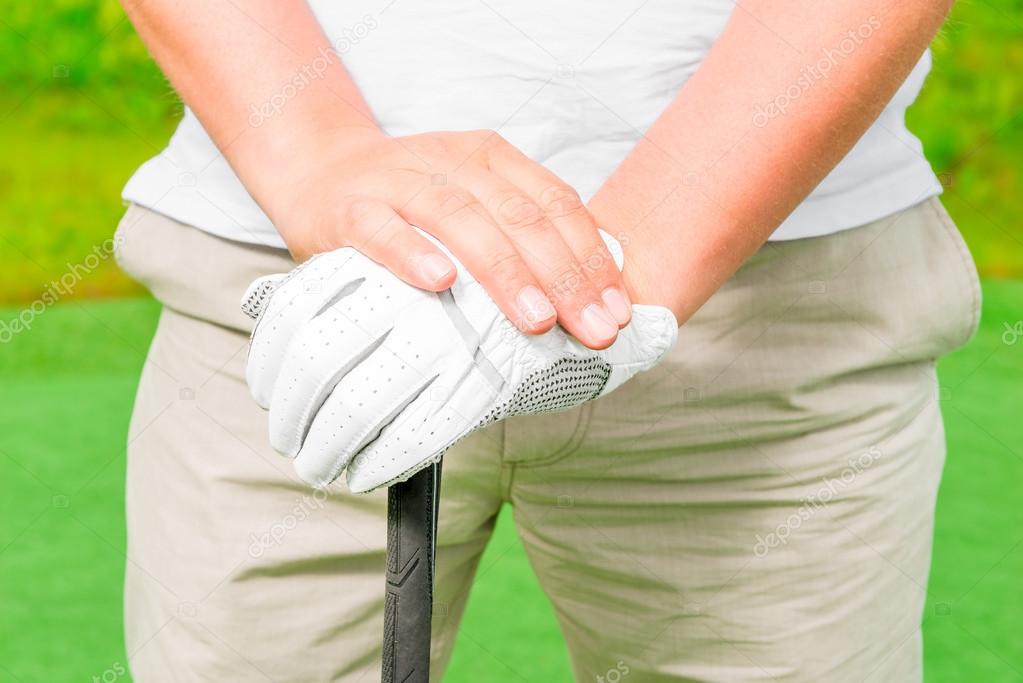 male hand in a glove with golf club close-up