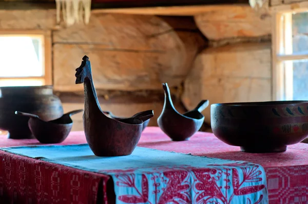 Carved wooden dishes on a table in rural house — Stock Photo, Image