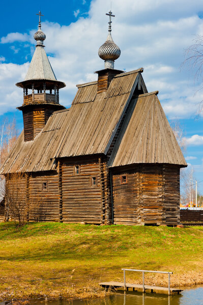 old wooden Orthodox church in the spring, vertical shot