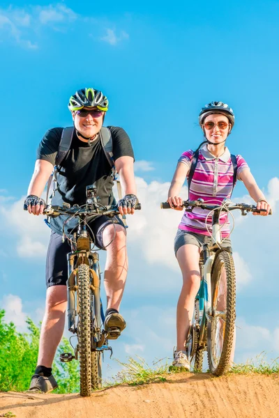 Happy couple on the bike on the mountain — Stock Photo, Image