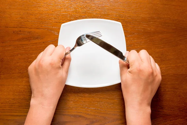 Man's hands and cutlery on the table top view — Stock Photo, Image