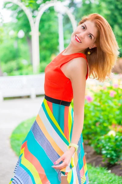 Active beautiful woman in a bright dress posing — Stock Photo, Image