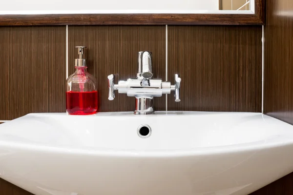 Sink with shiny faucet and soap close-up — Stock Photo, Image